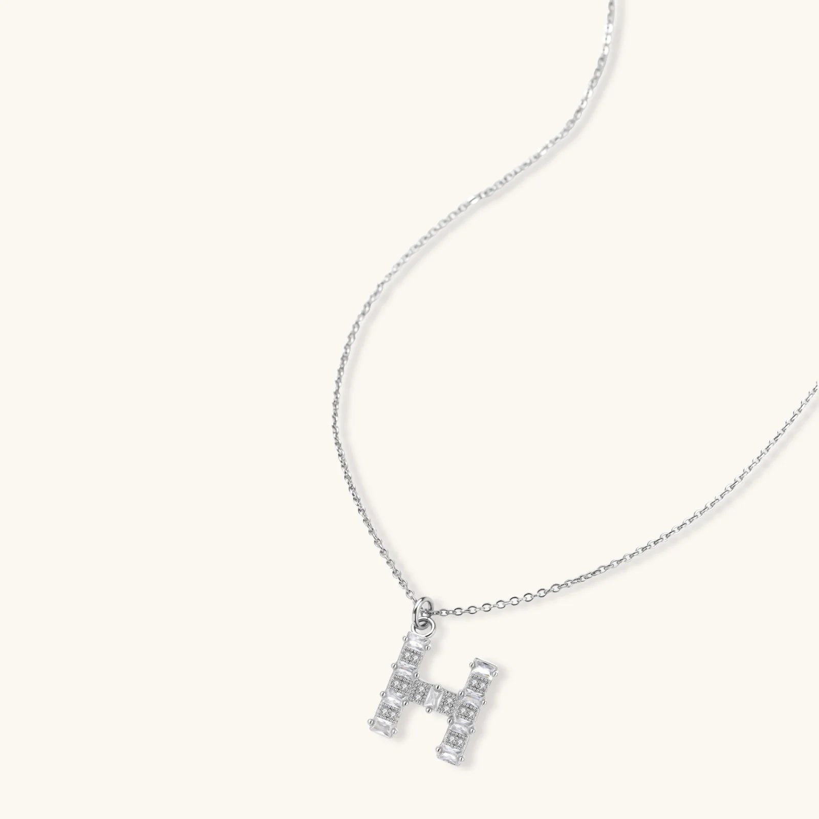 Letter H jewelry set featuring geometric crystal design in gold and white gold plated finish with adjustable chain necklace