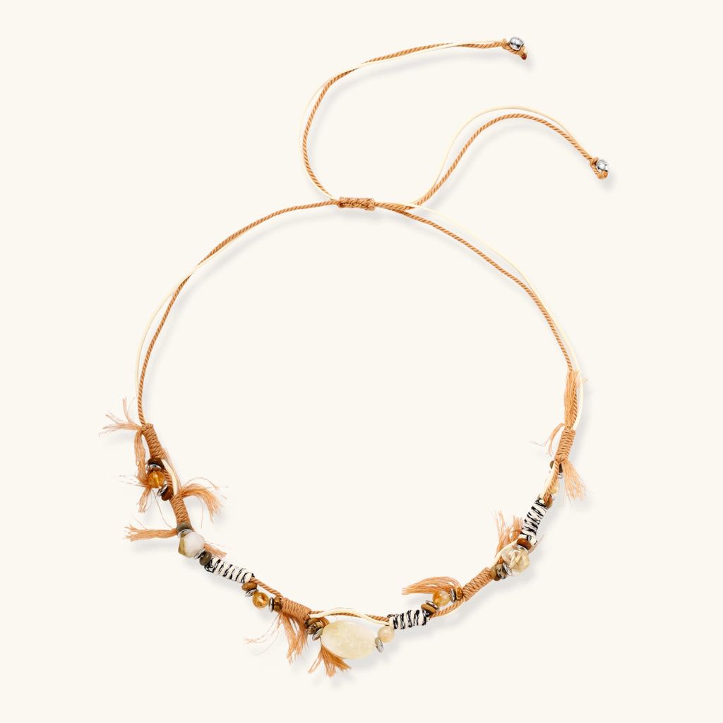 Adjustable brown cord necklace with citrine, coffee calcite beads and striped accents on white background.