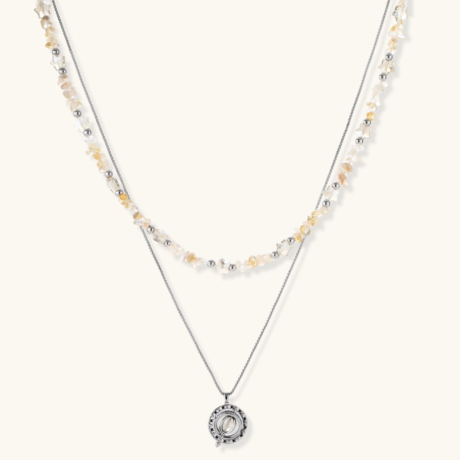 Complete jewelry set featuring citrine stone chips, silver beads, and cosmic circle pendants on cream background.